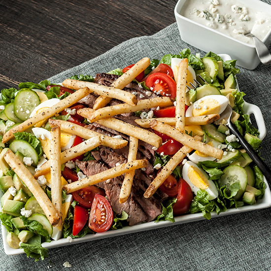 Pittsburgh Steak Salad featuring Simplot Kitchen Craft Cracked Pepper Sea Salt and Garlic Fries