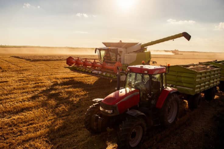 Combine parked next to tractor