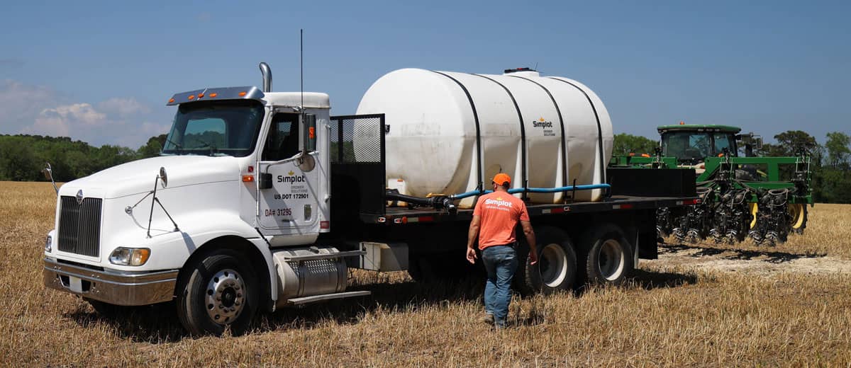 Man in Field in front of CDL Truck