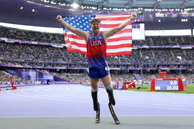 Hunter Woodhall holding the USA Flag