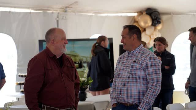 Chris Morgan visits with a guest at the Rock Springs event